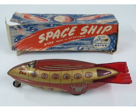 Wells Brimtoy friction powered tinplate Space Ship with gyro sparking motor, 194, in original box.&nbsp;