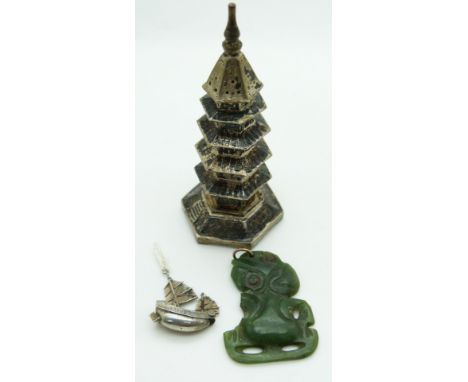 Chinese white metal model of a pagoda, a Chinese charm depicting a junk and a nephrite jade Maori tiki