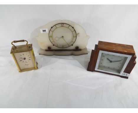 Three clocks to include a carriage clock marked Rapport, an Art Deco style wooden clock marked Bentina and similar (3)
