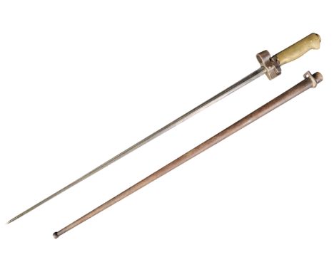 An original 19th Century French M1886 Lebel rifle bayonet. The bayonet having a smooth brass grip with working catch mechanis