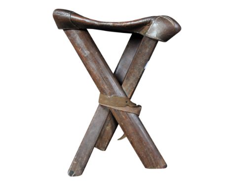 A WWI First World War British Army Sergeants field chair. The wooden three legged tripod base having a brown leather seat tha