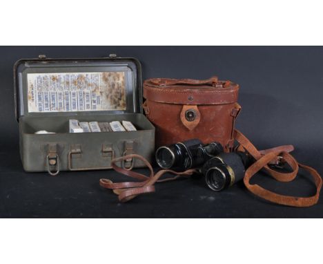A WWII Second World War US United States Army issue binoculars along with a Medical Corps First Aid tin. The 6x30 magnificati