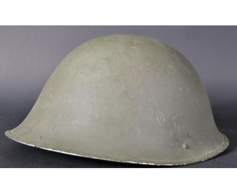 A vintage 1973 dated British Army MK IV steel combat ' turtle ' helmet. Usual ' turtle ' shape form with inner sock lined pad