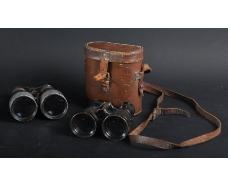 Two WWI First World War era British Army binoculars. Both pairs having broad arrow inspection marks to the outer body nearest