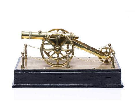 Brass scale model of a cannon 20th century, unsigned, on a black painted plinth, 32cm x 14.5cm x 17cm With a handwritten prov