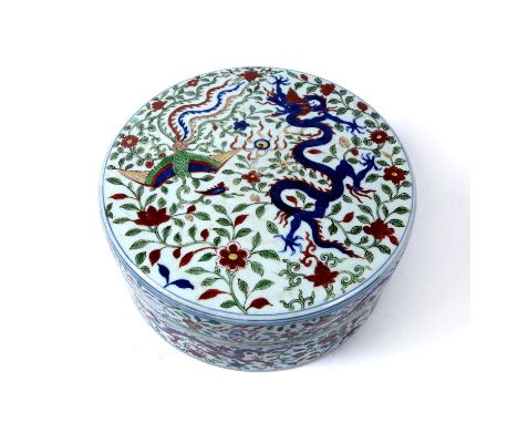 Circular box and coverChinese, decorated in the Wucai palette, depicting phoenixes and dragons, the base with six-character b