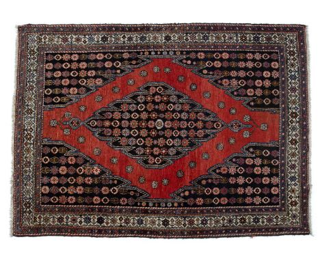 Saveh red ground rugwith central stylised panel and with foliate border, 188cm x 139cmSome light overall wear.