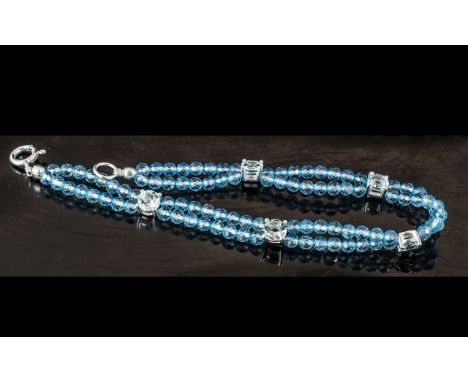 Sky Blue Topaz Station Bracelet, five round cut, sky blue topaz gems, claw set in silver mounts, spaced along a bracelet of d