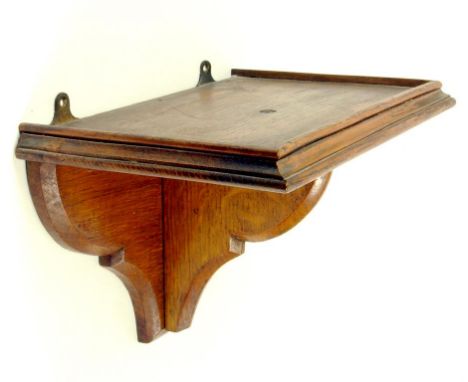 AN EDWARDIAN OAK CLOCK BRACKET 