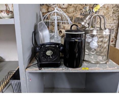Two polished metal and glass lantern style light fittings, a white painted birdcage ceiling light, a black cased telephone, a