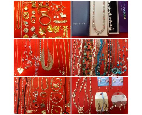 A large quantity of modern fashion jewellery to include gold tone chains, a Trifari gold tone heart brooch and other vintage 