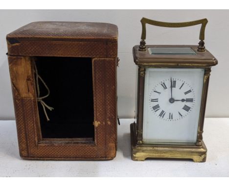 An early 20th century brass carriage clock, together with a travel case Location:If there is no condition report shown, pleas