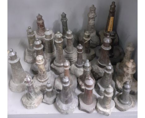 A large group of Cornish carved serpentine stone lighthouse models, the largest measuring 18cm and the smallest 7cm, to inclu