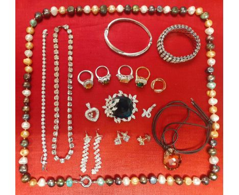A quantity of fashion rings to include late 20th Century Edco silver tone rings with coloured glass stones, a Michael Kors ro