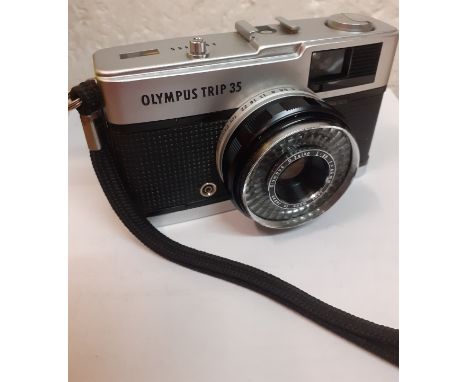 A late 1960's/1970's Olympus Trip 35 camera with slip case, serial number 2973455 having a silver tone shutter button. Locati