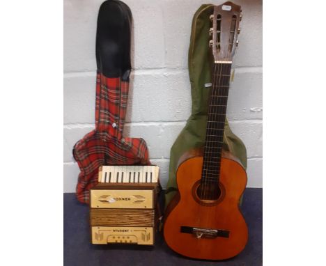 A Valencian Tatay guitar , a 1970's 'punk scene' tartan guitar slip case, a green slip case and a Hohner Student I piano acco