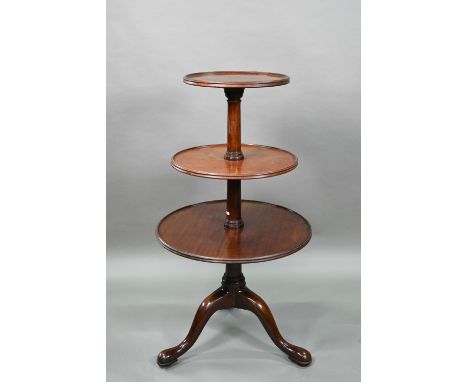 A Victorian mahogany dumb waiter, the graduated three circular tiers raised on a tripod base to brass castors, 60 cm dia. x 1