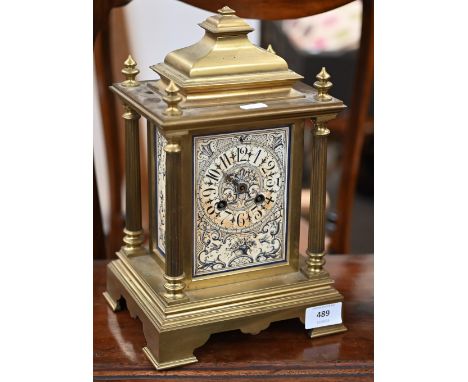 A 19th century French heavy brass mantel clock with ornately decorated dial and side panels, the Japy Frères drum movement st