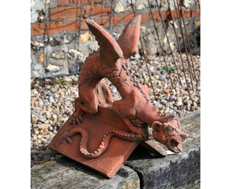 A reconstituted aged terracotta 'dragon' ridge tile, 43 cm high&nbsp; 