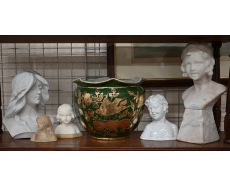 A carved alabaster bust of a child on plinth, to/w a smaller example and a bust of a woman, two ceramic busts and a green-gla