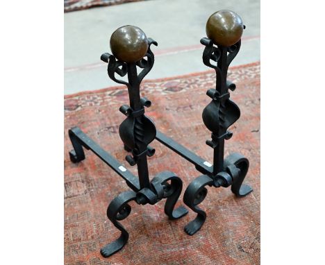 Pair of wrought iron and copper fire dogs, to/w a cast iron fireside companion suit of armour (lacks tools) (3) 