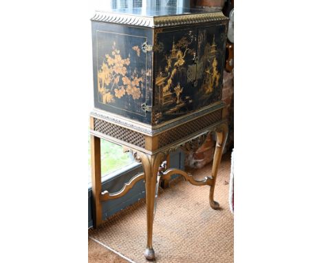 A mid-century Georgian style black Japanned and gilt pictorial cabinet on stand, the twin doors enclosing a shelf, 68 cm x 44