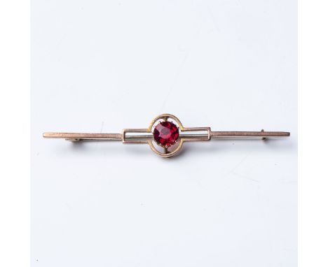 A GEM-SET BROOCH  Claw-set to the center with a round brilliant-cut gemstone, possibly ruby, in an Art Deco design,Â&nbsp;in 