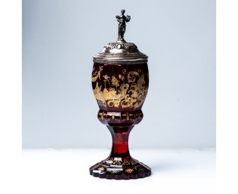 A BOHEMIAN RUBY GLASS GOBLET WITH SILVER COVER, CIRCA 1850  The faceted ovoid bowl enamelled and gilt with medieval figures u