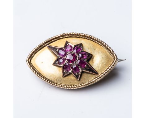A RUBY BROOCH  Claw-set to the center with 9 rubies in a star design, with a combined weight of approximately 1,00 carats, se