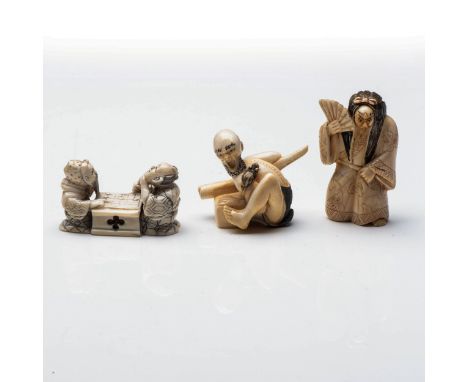 A JAPANESE IVORY 'NOH ACTOR' NETSUKE The actor holding a fan and dressed in a voluminous robe, the face rotating; together wi