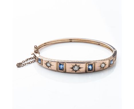A SAPPHIRE AND DIAMOND BANGLE LONDON 1894, ARTHUR JACK &amp; CO. Star set to the center with a rose-cut diamond weighing appr