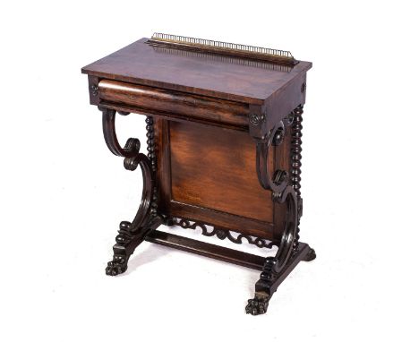 A ROSEWOOD OCCASIONAL TABLE  The rectangular top with pierced brass gallery, frieze drawer, moulded trestle support with carv