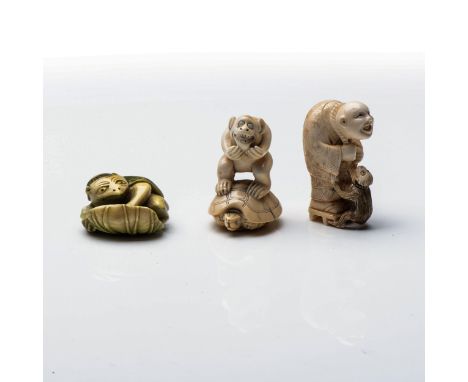 A JAPANESE IVORY 'KAPPA' NETSUKE The mythological Kappa seated atop a lotus leaf, all stained green; together with a monkey a