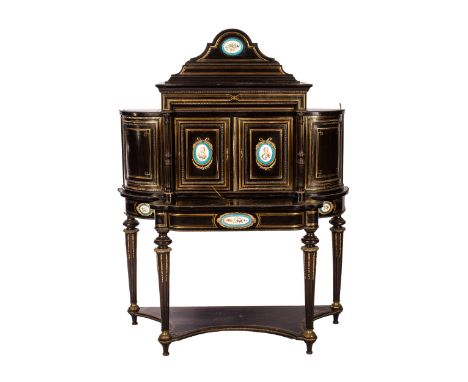 A FRENCH EBONISED AND PORCELAIN-MOUNTED BONHEUR DU JOUR  The upper section surmounted by a shaped cresting centering a flower