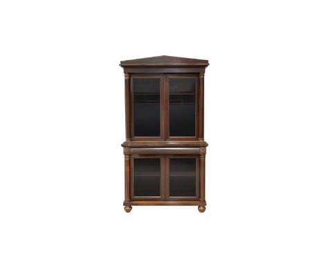 A Victorian rosewood bookcase, the architectural pediment above a pair of glazed doors enclosing adjustable shelves, the base