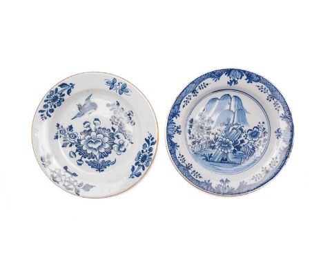 A mid-18th century Delftware blue and white dish, decorated with a bird in flight above Chinese style flowers, brown edged ri