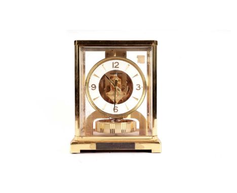 A Jaeger LeCoultre Atmos clock, with canted brass and glass case, arabic numerals at the quarters, numbered 413562, 23cms hig