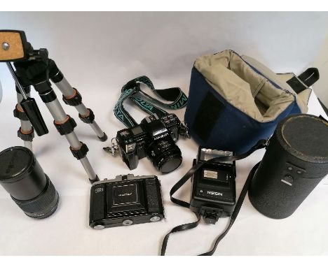 A collection of cameras and camera lenses to include,Zeiss Ikon Nettar 517/16 folding camera, vintage Nissin 360 TW tilt head