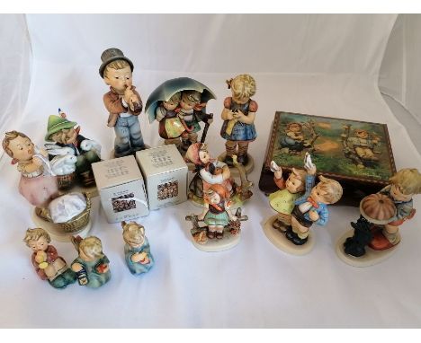 A collection of twelve Goebel Hummel figurines and music box. Including "Serenade", "A Stitch in Time" and wash day. The tall