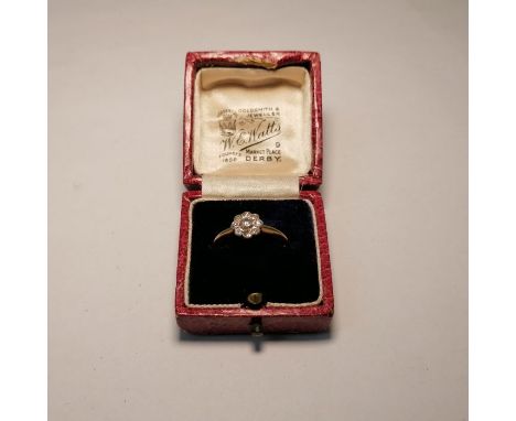 An early 20th century diamond daisy ring. Stamped 18ct. Approximate weight&nbsp; 2 grams. Size L. Along with a vintage W.E. W