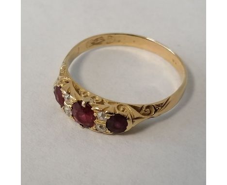 A ruby and diamond half hoop ring, with carved raised mount in the Victorian style. With scratched 18ct hallmark for Chester.