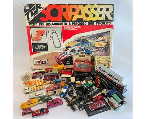 A collection of vintage diecast and other toy cars along with a boxed Scalextric style set