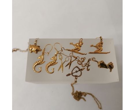 A collection of 9ct gold hallmarked and 375 stamped jewellery featuring charms such as a pig, a swinging cat pendant, two sci