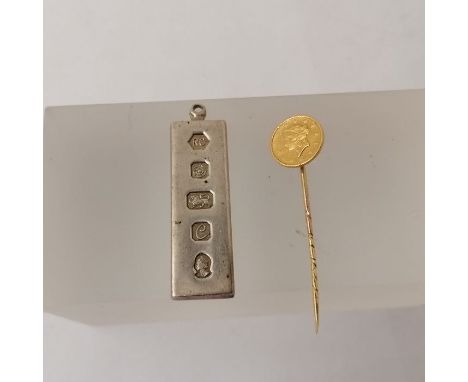 A tie pin formed from an 1851 gold United States dollar, approximate weight 2.6 grams along with a Sterling silver Queen Eliz