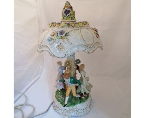 A 20th Century porcelain figural lamp (untested). Approximately 57 cm highSome small losses.