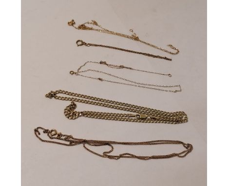 A collection of chains - featuring a 9ct gold flat curb chain. Alongwith a finer 9ct rose gold curb chain and three yellow me
