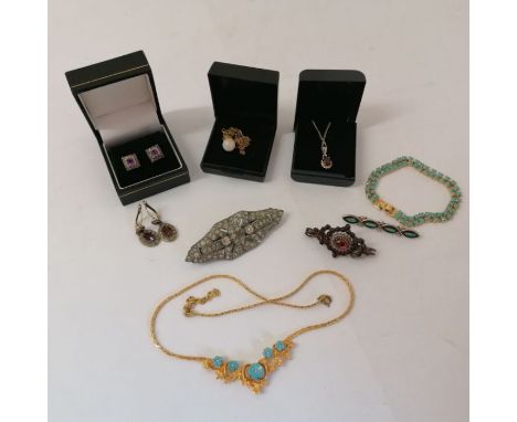 A selection of silver and costume jewellery. To include a garnet and seed pearl Georgian/early 19th century jewellery element