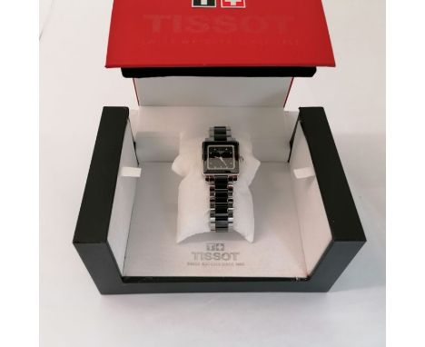 A diamond set Tissot Cera ladies wristwatch. Featuring a square dial and bezel and a black ceramic and stainless steel bracel