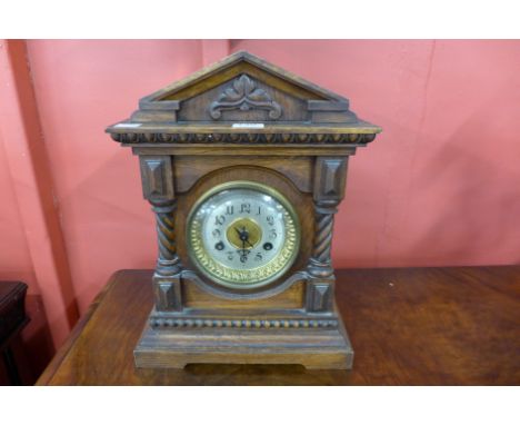 A 19th Century German Junghans carved oak bracket clock