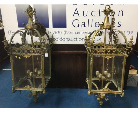A large pair of brass and glass hanging light fittings, 120cm high x 37cm wide